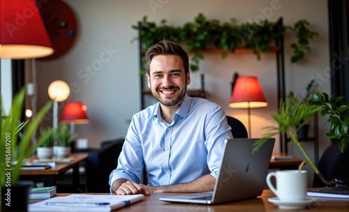 businessman smiling working on laptop in cafe