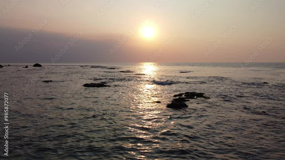 Sunset at Anyer beach, Indonesia. Aerial view of sunset or sunrise on the sea, dramatic sunlight reflection on the beach. Sunset at Anyer beach, Indonesia. Aerial view of sunset or sunrise on the sea, dramatic sunlight reflection on the beach.