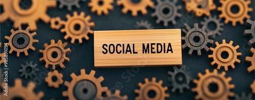 Wooden SOCIAL MEDIA block with scattered gears on a dark surface symbolizing digital networking. photo