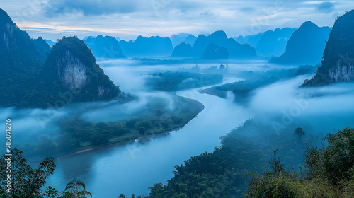 Mist-Shrouded Peaks of Tranquility: A Serene River Winds Through a Mystical Mountain Landscape