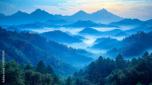 Blue Hour Majesty: Majestic mountain peaks pierce a sea of clouds, bathed in the serene blue hues of dawn. 