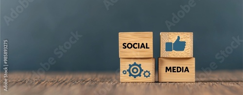 Wooden blocks with SOCIAL MEDIA text, gear and like icons representing digital communication and interaction. photo