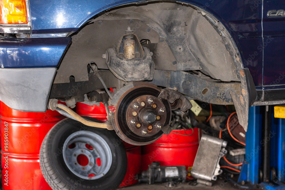 Fototapeta premium Tire replacement. Disc brake of the vehicle for repair, in process