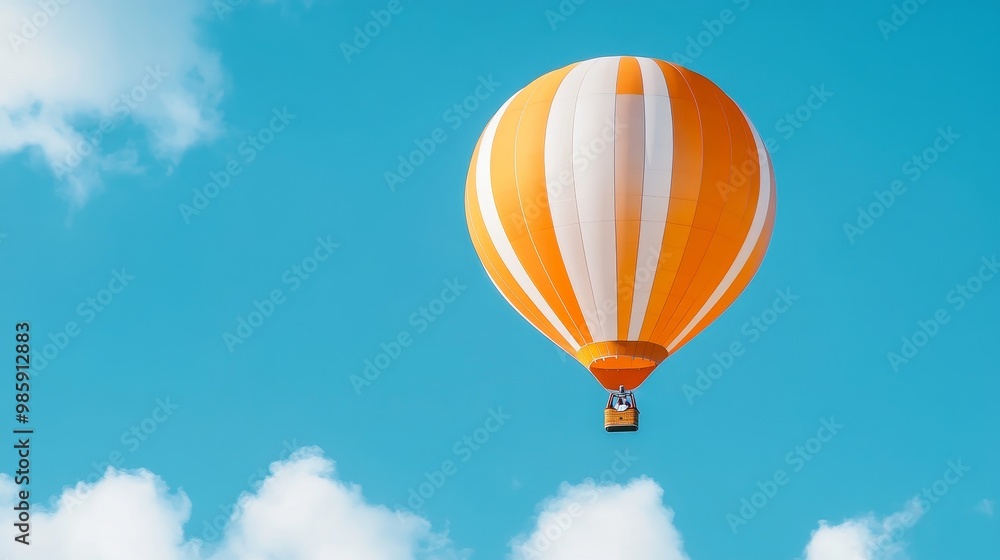 Naklejka premium Orange and White Hot Air Balloon Soaring in the Sky, symbolizes freedom, adventure, exploration, travel, and joy.