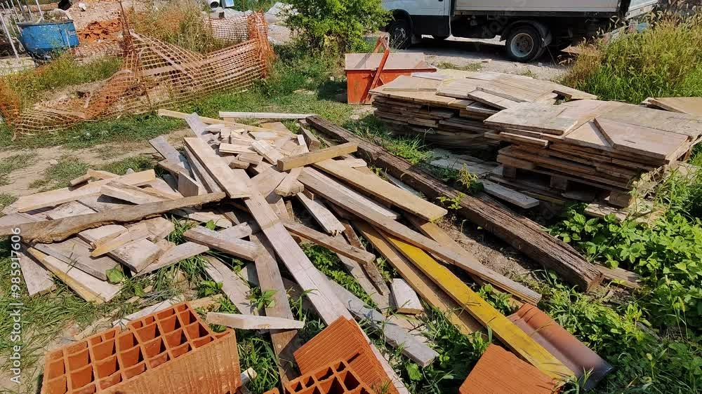 Construction Site Debris: Discarded Wood and Building Materials in Outdoor Setting Construction Site Debris: Discarded Wood and Building Materials in Outdoor Setting