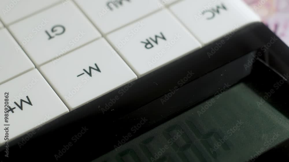 White modern calculator with close up buttons for counting money and doing business and good capital gains. Calculator buttons rotate, close up. Business accounting work concept. Counting money White modern calculator with close up buttons for counting money and doing business and good capital gains. Calculator buttons rotate, close up. Business accounting work concept. Counting money