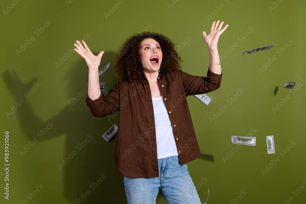 Photo of pretty young woman flying banknotes wear brown shirt isolated on khaki color background Photo of pretty young woman flying banknotes wear brown shirt isolated on khaki color background