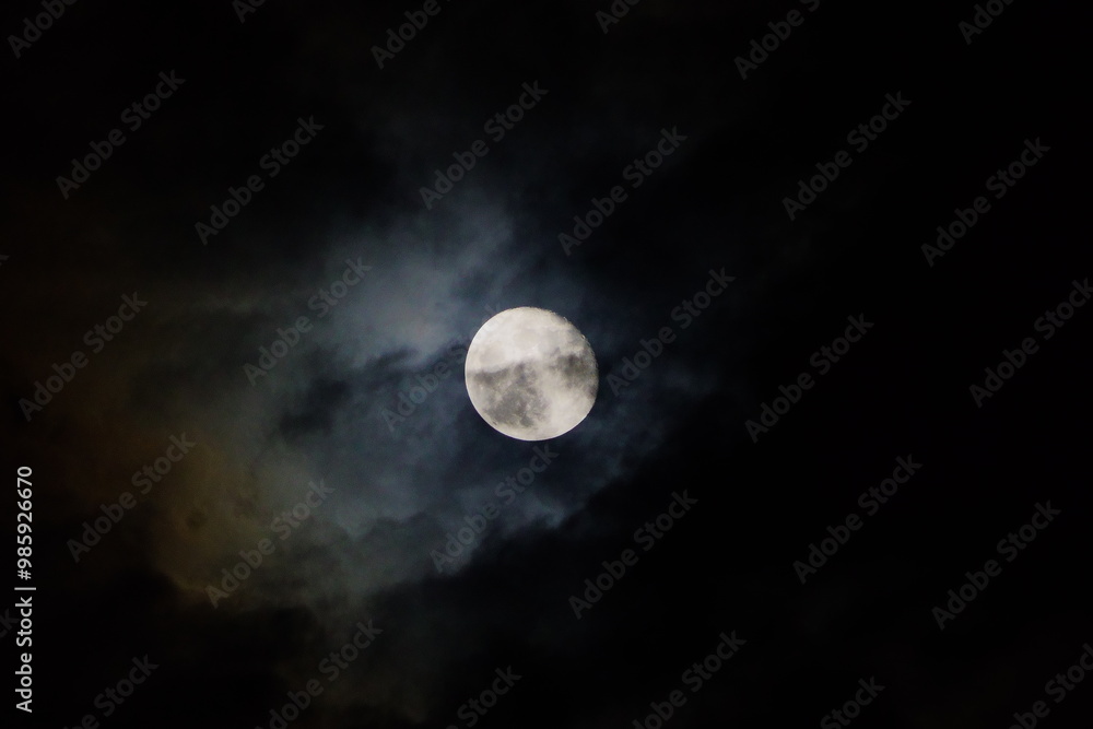 A moon in the dark cloudy cold night. A moon in the dark cloudy cold night.