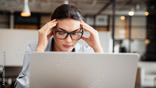 Tired businesswoman with headache in office