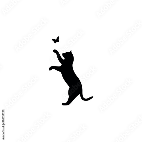 a cat standing on its hind legs with its front paws up in the air. The cat appears to be reaching up towards a small butterfly that is flying in front of it