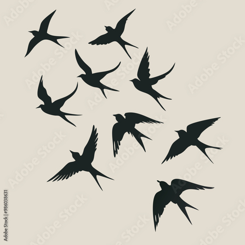 a group of nine birds flying in a random pattern. The birds are black and are silhouetted against a white background