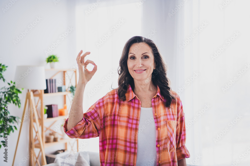 Photo of positive good mood woman dressed shirt showing you okey sign indoors house apartment room Photo of positive good mood woman dressed shirt showing you okey sign indoors house apartment room