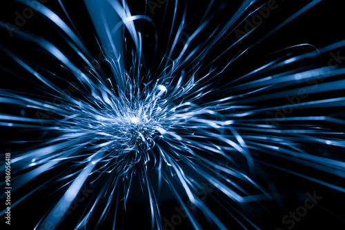 blue sparks from the grinder glowing in the dark