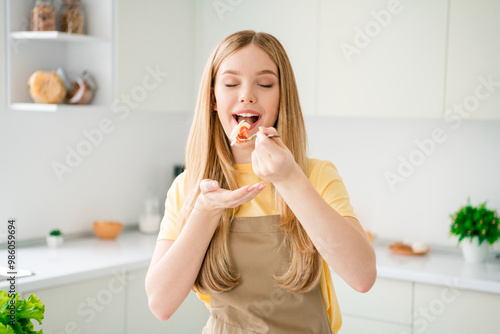 Photo of charming adorable girl eating tasty meal organic vegetable salad healthy food indoors house kitchen