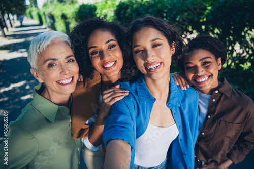 Tableau sur toile Photo portrait of happy multi generational women take selfie photo having fun to