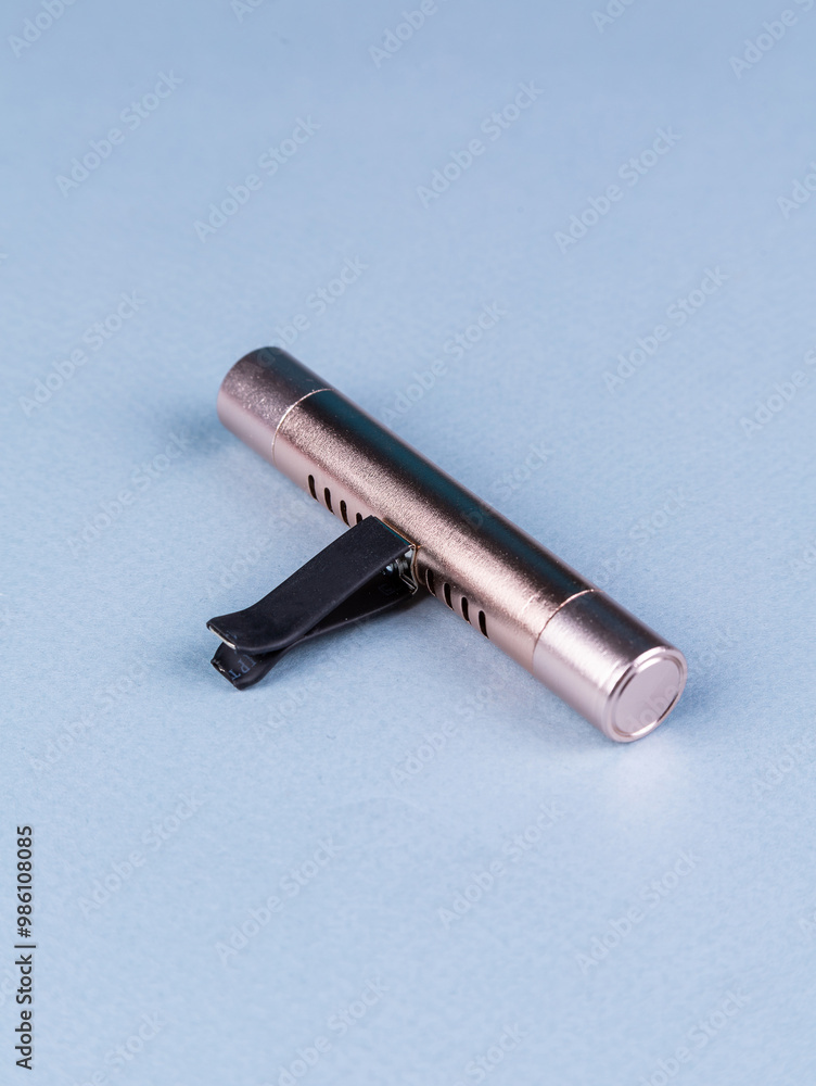 close up of car air freshener for mounting on deflector on blue background