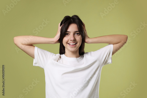 Portrait of cute teenage girl on olive background