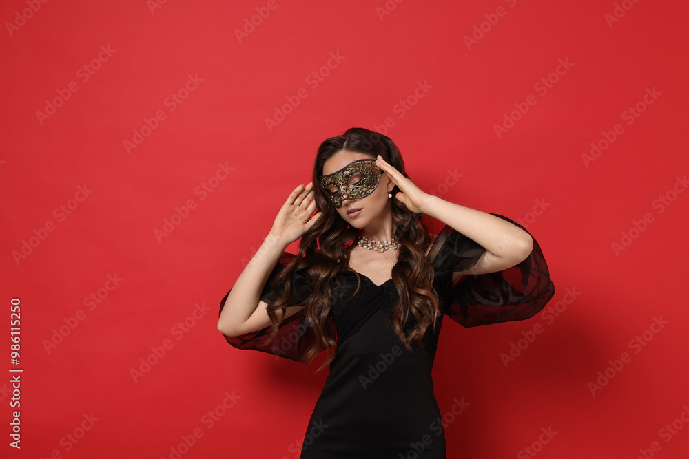 Beautiful woman wearing carnival mask on red background. Space for text Beautiful woman wearing carnival mask on red background. Space for text