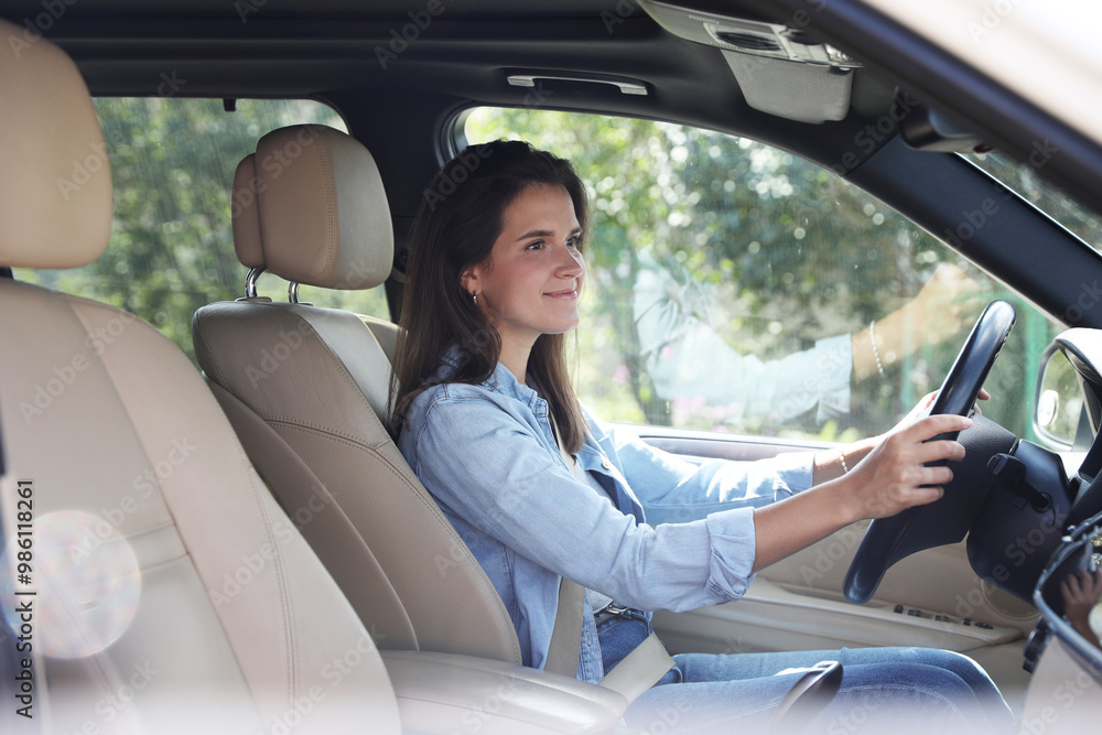 Woman holding steering wheel while driving car Woman holding steering wheel while driving car