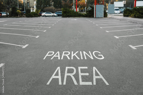 Empty outdoor parking lot with painted markings on asphalt