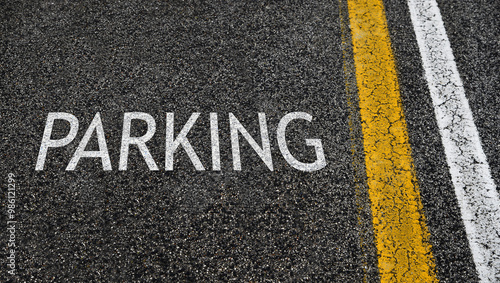 Parking lot. Word Parking written on asphalt