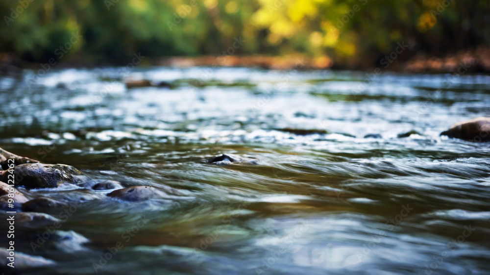 Blurred bokeh of a calm, flowing river Blurred bokeh of a calm, flowing river