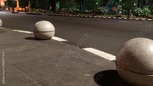 Stone bollard on the side of the road in the city