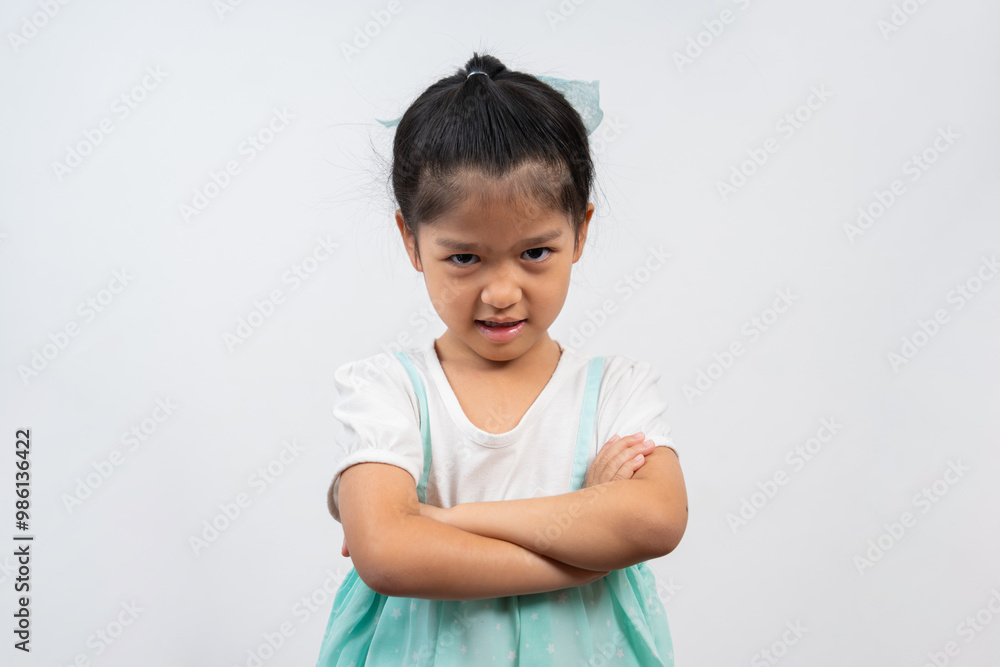 Portrait of Asian angry and sad little girl on white isolated background, The emotion of a child when tantrum and mad, expression grumpy emotion. Kid emotional control concept Portrait of Asian angry and sad little girl on white isolated background, The emotion of a child when tantrum and mad, expression grumpy emotion. Kid emotional control concept