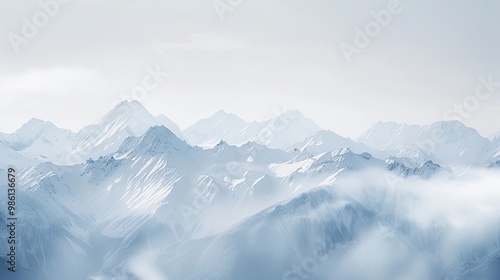 Softened snow-covered peaks with blurred cloudy sky for chilly mountain backdrop