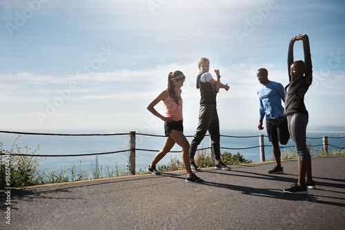 People, outside and stretching on road for fitness with running for exercise and workout. Friends, outdoor and committed or active in sportswear with warm up for health, wellbeing and self care
