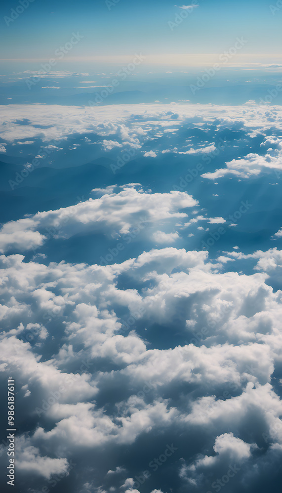 Aerial view of fluffy white clouds against a blue sky, with distant mountain silhouettes visible through the clouds. The scene captures a serene and tranquil atmosphere. Aerial view of fluffy white clouds against a blue sky, with distant mountain silhouettes visible through the clouds. The scene captures a serene and tranquil atmosphere.