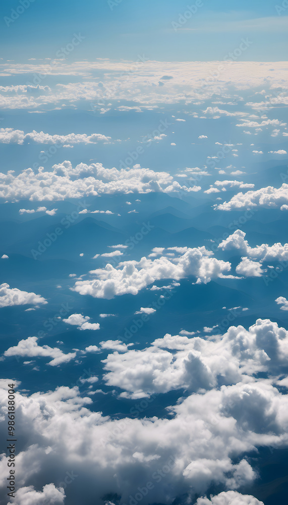 Aerial view of fluffy white clouds against a blue sky, with distant mountain silhouettes visible through the clouds. The scene captures a serene and tranquil atmosphere. Aerial view of fluffy white clouds against a blue sky, with distant mountain silhouettes visible through the clouds. The scene captures a serene and tranquil atmosphere.