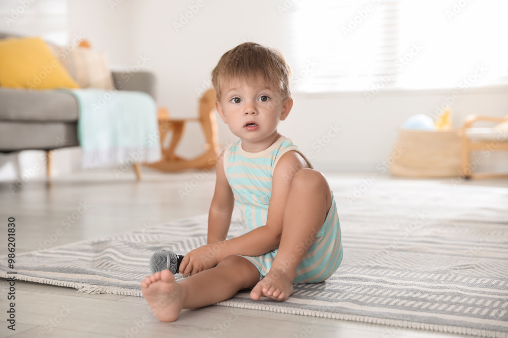 Cute little baby with microphone on floor at home Cute little baby with microphone on floor at home