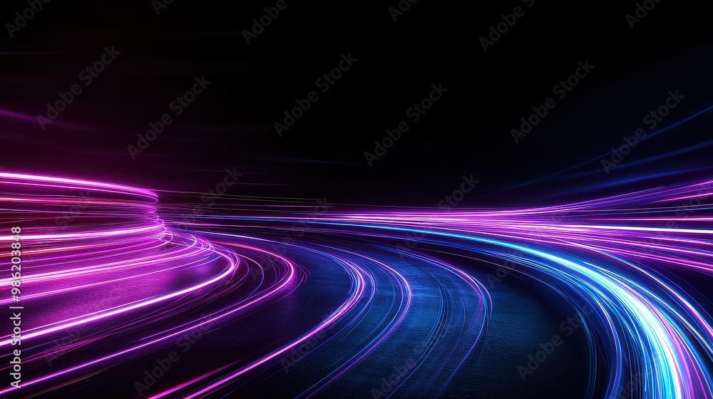 A long, curvy road with purple and blue lights. The road is illuminated with a purple and blue hue, creating a sense of motion and energy. The lights seem to be moving along the road
