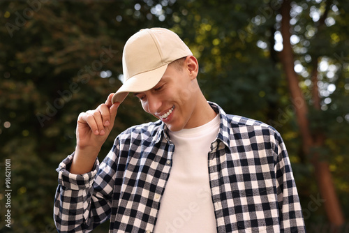 Photography Portrait of smiling man in baseball cap outdoors