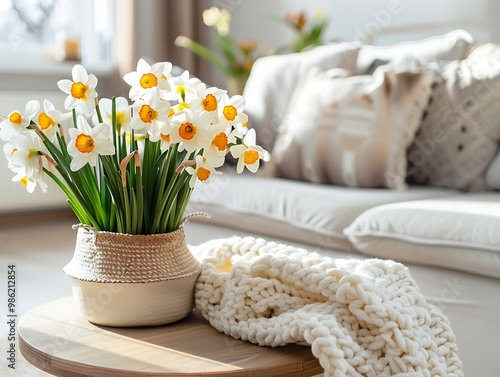 white daffodils in vase on table in living room photo