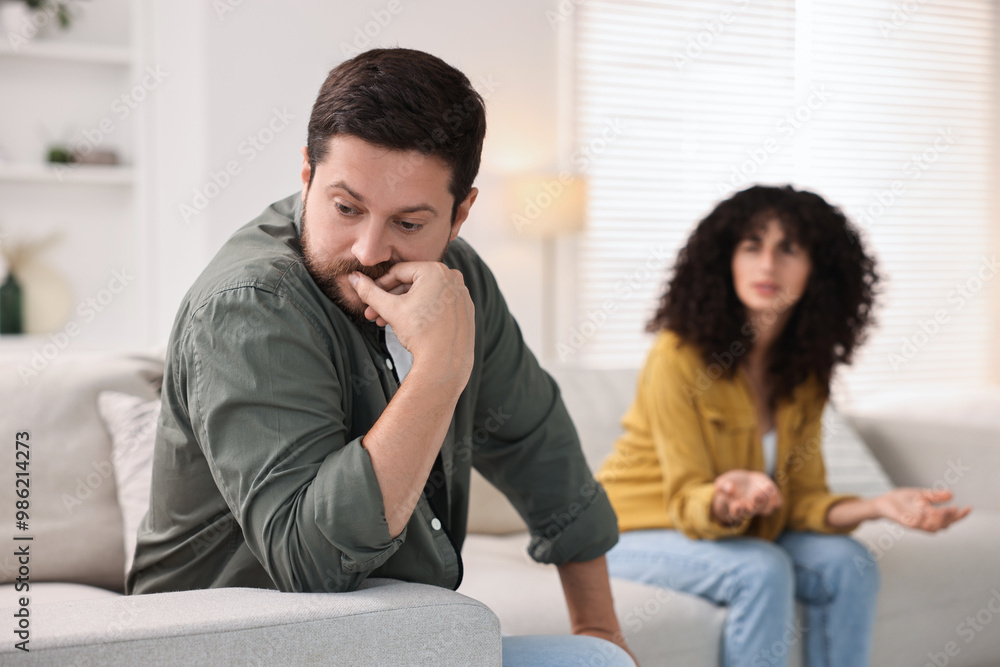 Couple having quarrel on sofa at home, selective focus. Relationship problems Couple having quarrel on sofa at home, selective focus. Relationship problems