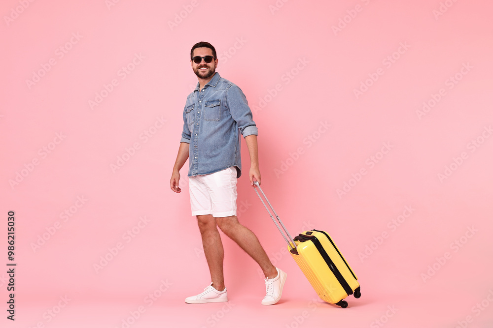 Happy man in sunglasses with suitcase on pink background Happy man in sunglasses with suitcase on pink background