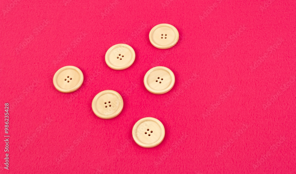 Wooden buttons on a pink fleece fabric Wooden buttons on a pink fleece fabric