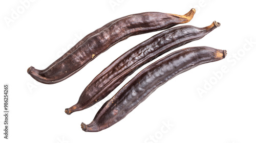 Dried carob pods on transparent background highlighting natural texture and rich color