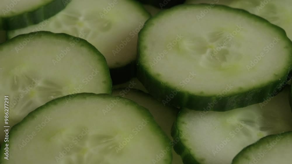 Fresh cucumber sliced in pile background rotating macro video Fresh cucumber sliced in pile background rotating macro video