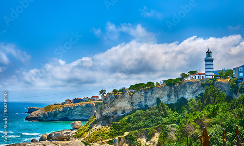 Sile, Turkey, Lighthouse on the rocky shore of the Black Sea against a background of blue sky with clouds.