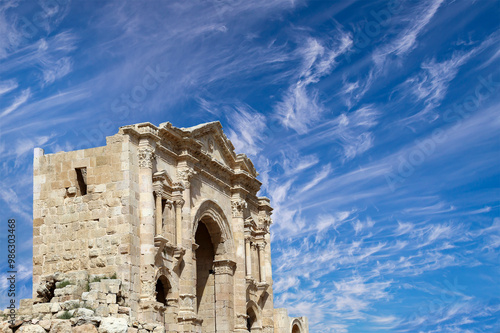 Arch of Hadrian in Gerasa (Jerash)-- was built to honor the visit of emperor Hadrian to Jerash in 129/130 AD, Jordan. Against the background of a beautiful sky with clouds #986303468