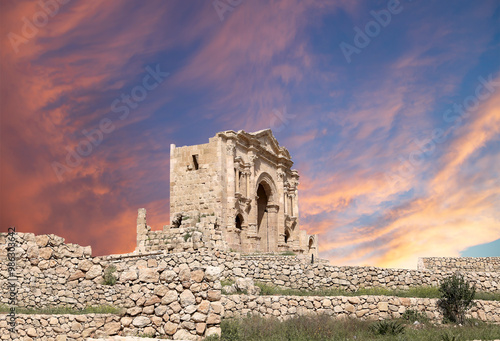 Arch of Hadrian in Gerasa (Jerash)-- was built to honor the visit of emperor Hadrian to Jerash in 129/130 AD, Jordan. Against the background of a beautiful sky with clouds #986303642