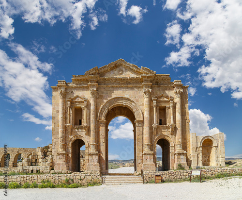 Arch of Hadrian in Gerasa (Jerash)-- was built to honor the visit of emperor Hadrian to Jerash in 129/130 AD, Jordan. Against the background of a beautiful sky with clouds #986304699