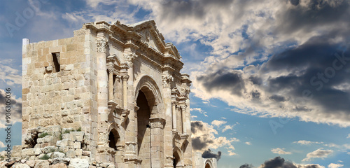 Arch of Hadrian in Gerasa (Jerash)-- was built to honor the visit of emperor Hadrian to Jerash in 129/130 AD, Jordan. Against the background of a beautiful sky with clouds #986305036