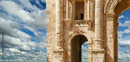 Arch of Hadrian in Gerasa (Jerash)-- was built to honor the visit of emperor Hadrian to Jerash in 129/130 AD, Jordan. Against the background of a beautiful sky with clouds #986305293