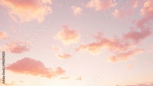 Fototapeta Naklejka Na Ścianę i Meble -  Pastel pink and orange sky during the golden hour, with light clouds scattered across