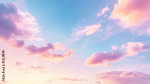 Clear blue sky with soft pastel tones of pink and white as the sun sets