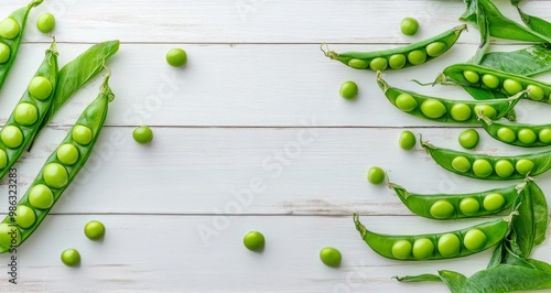 Fresh green peas and pods arranged on a rustic wooden table with scattered peas